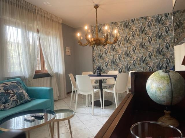 a living room with a couch and a table and chairs at La Bomboniera in Cervia