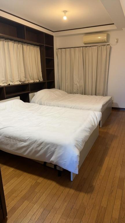 Postel nebo postele na pokoji v ubytování Jl千住別荘