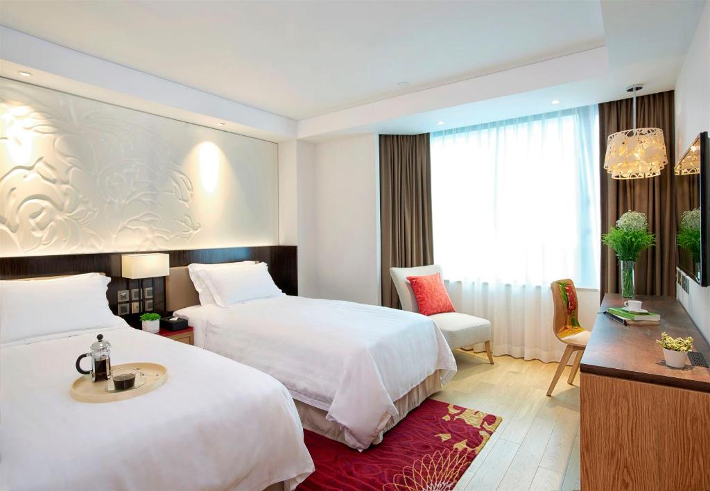 Katil atau katil-katil dalam bilik di Wharney Hotel