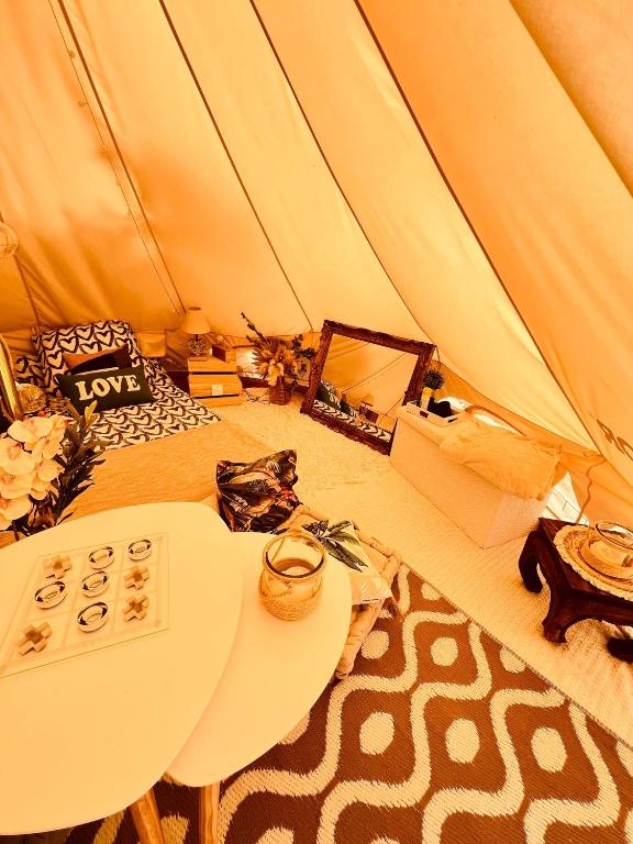 a room with a tent with a table in it at LOVE ROOM Tente Lodge spa MFG chez C&C, exclusivement réservée aux ADULTES in Cantaron