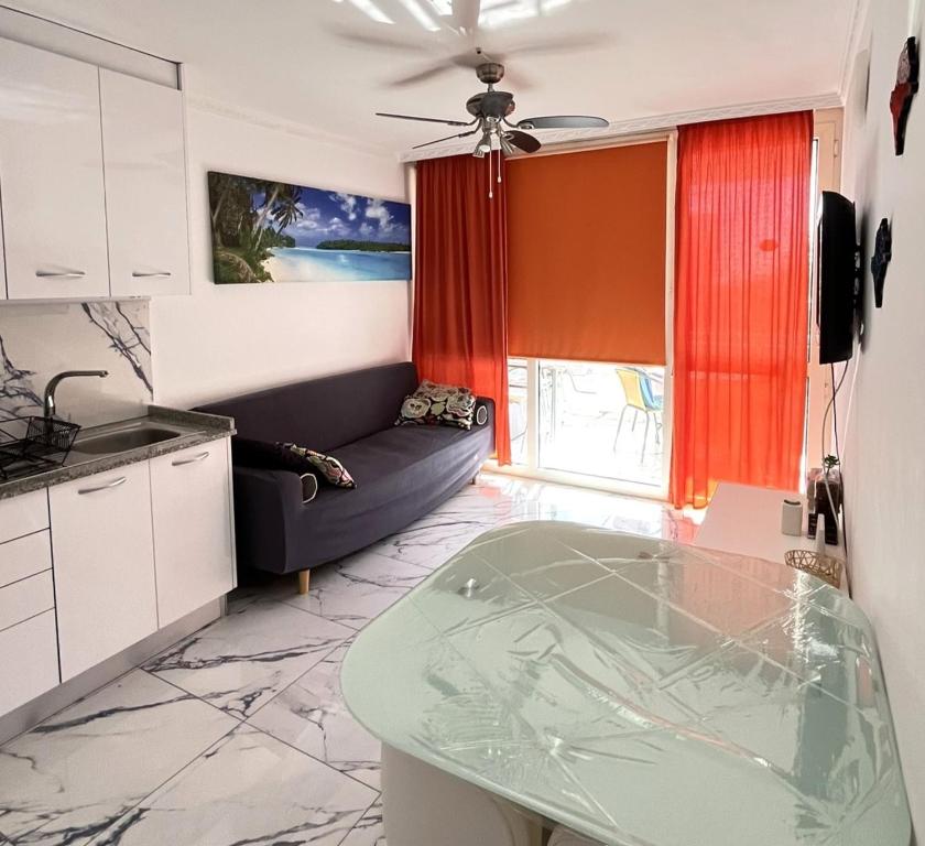 a kitchen with a couch and a table in a room at Río Canario 102 in Mogán