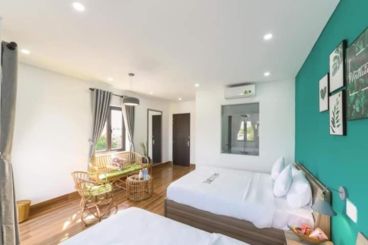 Postel nebo postele na pokoji v ubytování Kivi Homestay Hoi An
