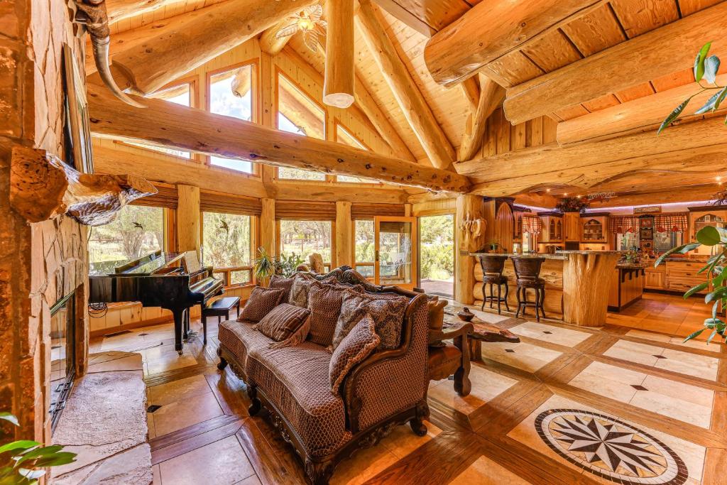 a living room with a couch and a piano at Scenic Payson Cabin! Fireplace and Wraparound Patio in Payson
