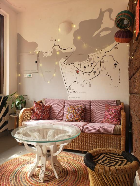 a living room with a couch and a table at Laxmi Happy Home in Querim Goa in Querim