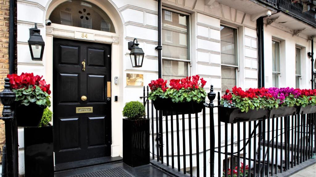 a black door and flowers on a house at The Sumner Hotel in London
