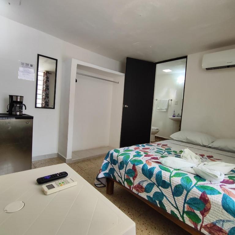 a bedroom with a bed and a table and a mirror at Margaritas in Cancún