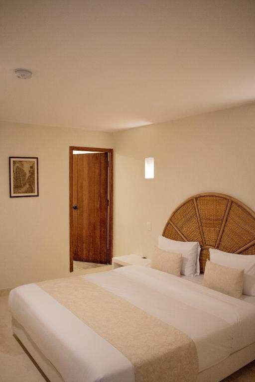 Postel nebo postele na pokoji v ubytování Casa Noa Colonial Rooms