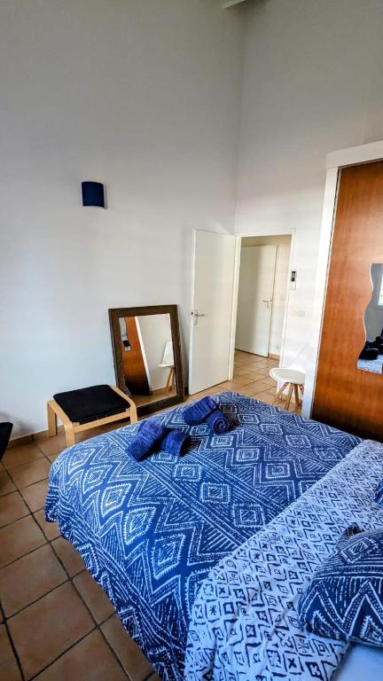 a bedroom with a blue bed and a mirror at Villa MIA in Saint-François