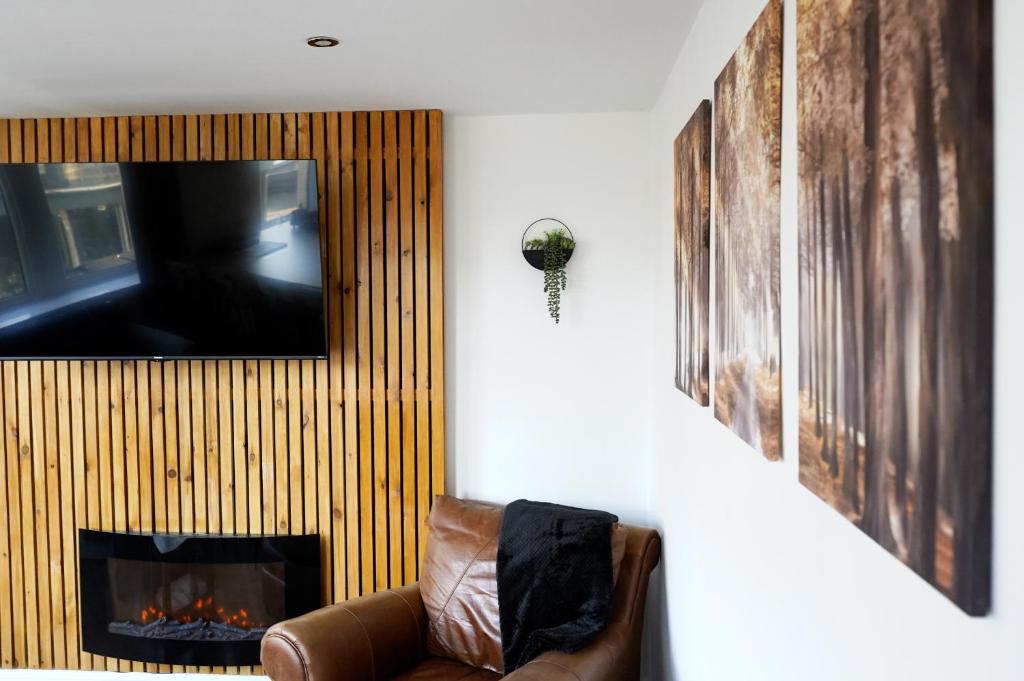a living room with a couch and a fire place at Church Street Studio Apartment in Keighley