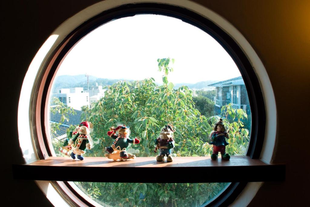 a window with a group of toy figurines on it at Sanyi Happiness B&B in Sanyi