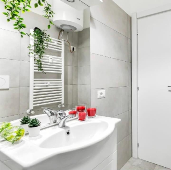 a bathroom with a white sink and a mirror at Venezuela in Milan