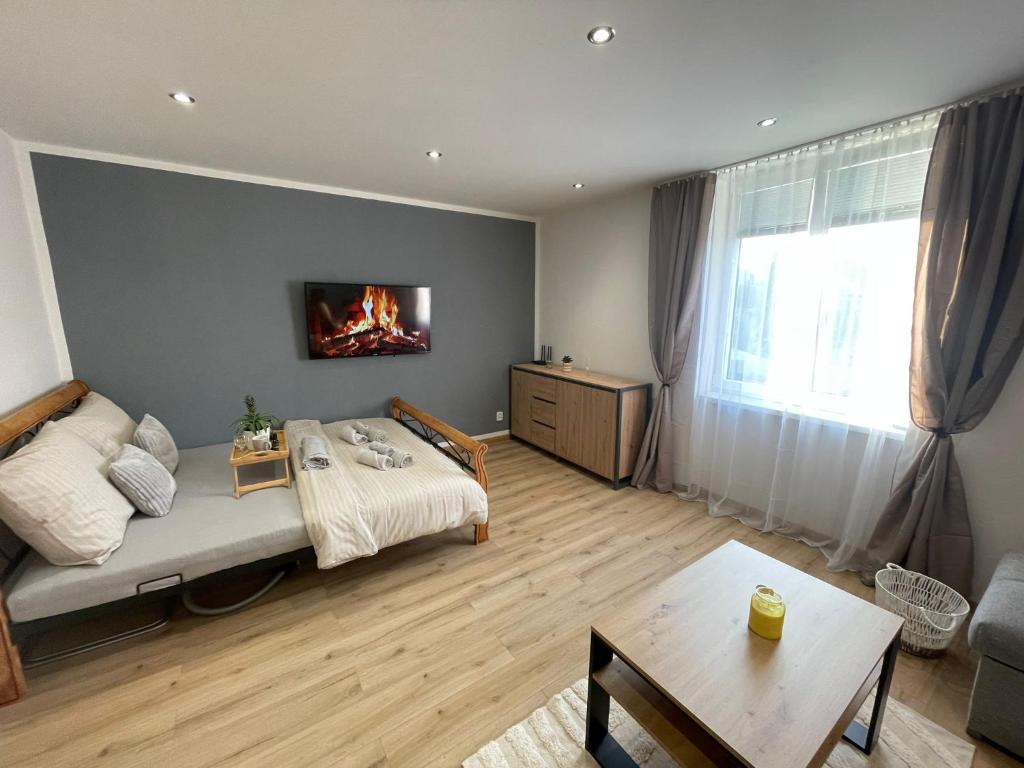 a living room with a bed and a fireplace at ZnojmoApartment in Znojmo