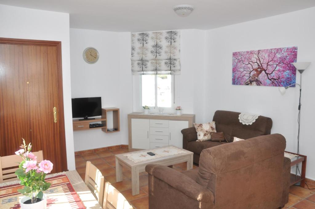 a living room with a couch and a chair at Atiko Welcome in Arcos de la Frontera