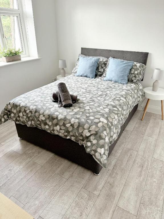 a bedroom with a large bed with blue pillows at Flat 12 Palm Court in Bournemouth