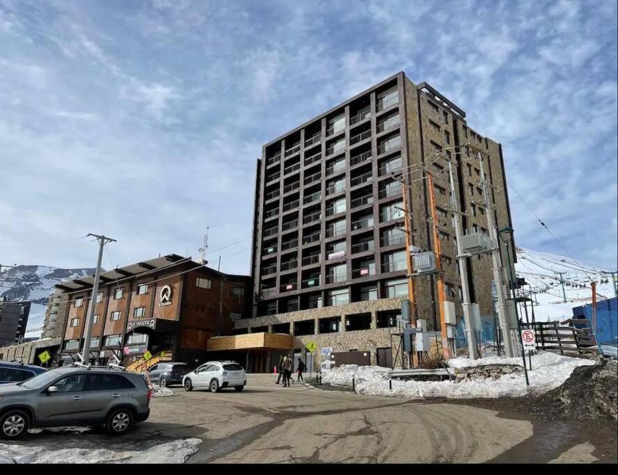 a tall building on the side of a street at Gran Parador SKI In SKI Out El Colorado Chile in El Colorado