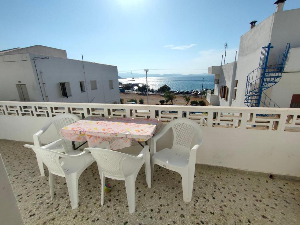 a table and chairs on a balcony with a view at Naxos Crafts' House in Naxos Chora