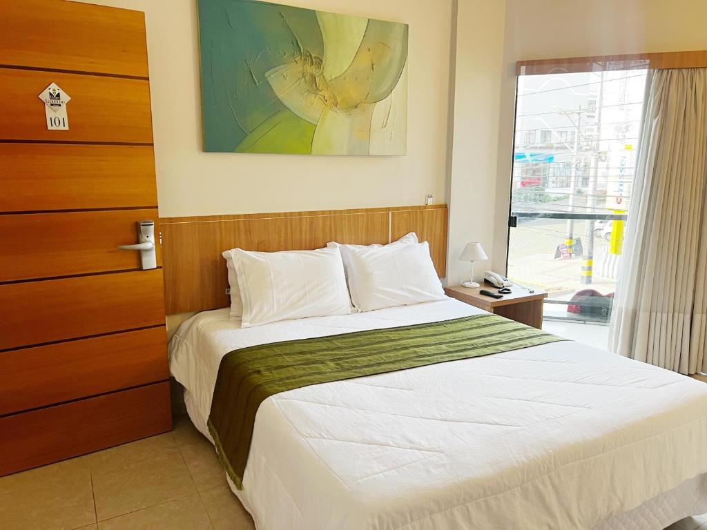 Postel nebo postele na pokoji v ubytování Hotel Dom Leopoldo