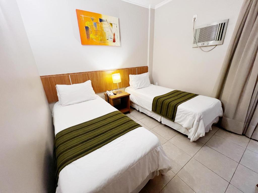Postel nebo postele na pokoji v ubytování Hotel Dom Leopoldo