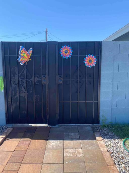 a black gate with butterflies on the sides of it at Villa New Place in Las Vegas