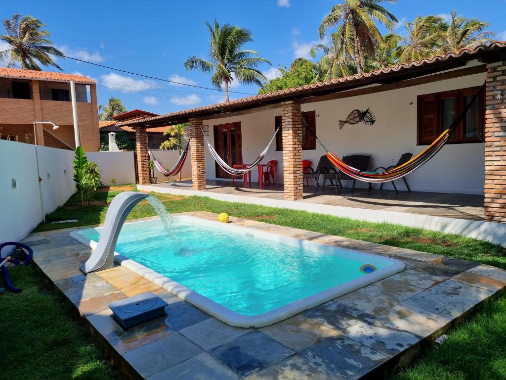 a pool in the backyard of a house at Casa Teodoro!!! in Trairi