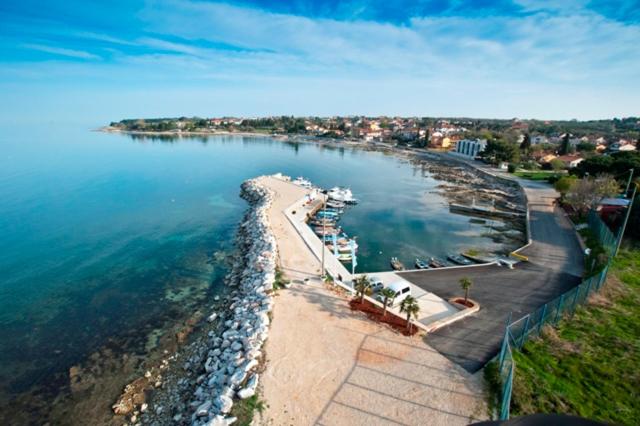 z powietrza widok na plażę i wodę w obiekcie Apartments Dolcea w mieście Umag