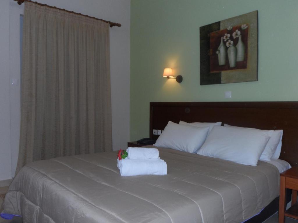 a bedroom with a bed with two towels on it at Filoxenia Marias in Loutra Ipatis