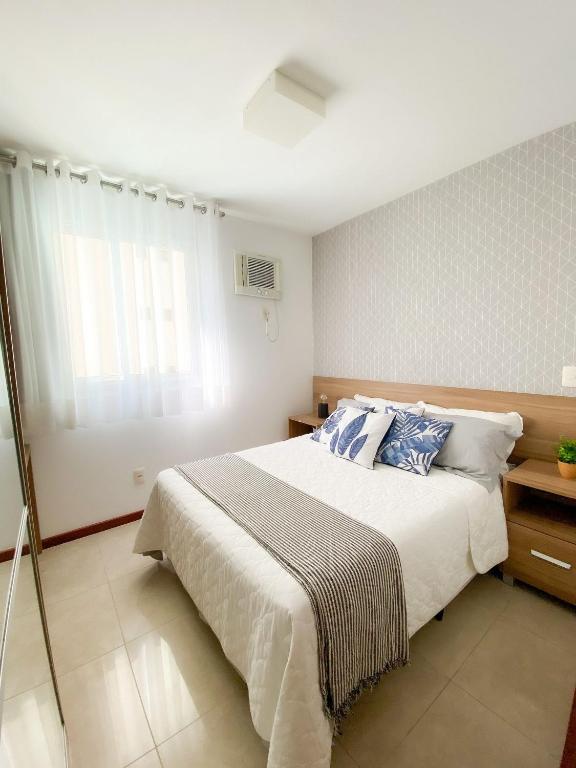 a bedroom with a large bed and a window at Atlantis by Mosaico Stays in Vitória