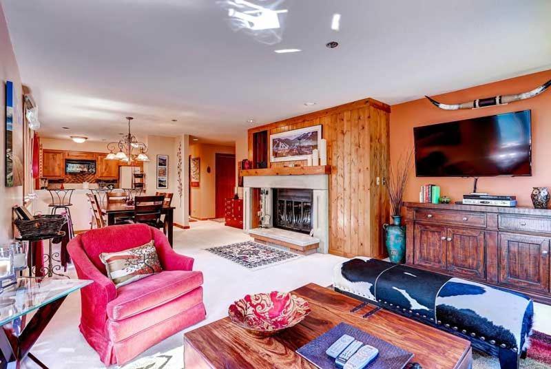 a living room with a couch and a fireplace at Kiva 336 by East West Hospitality in Beaver Creek