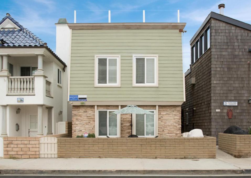 a house with a brick fence in front of it at 3 Bedrooms in Newport Beach