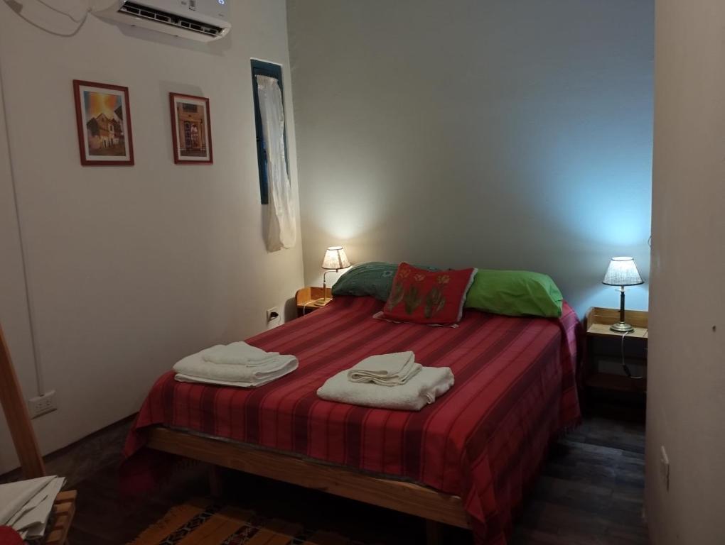 a bedroom with a bed with two towels on it at Solar de Fanny in Cordoba