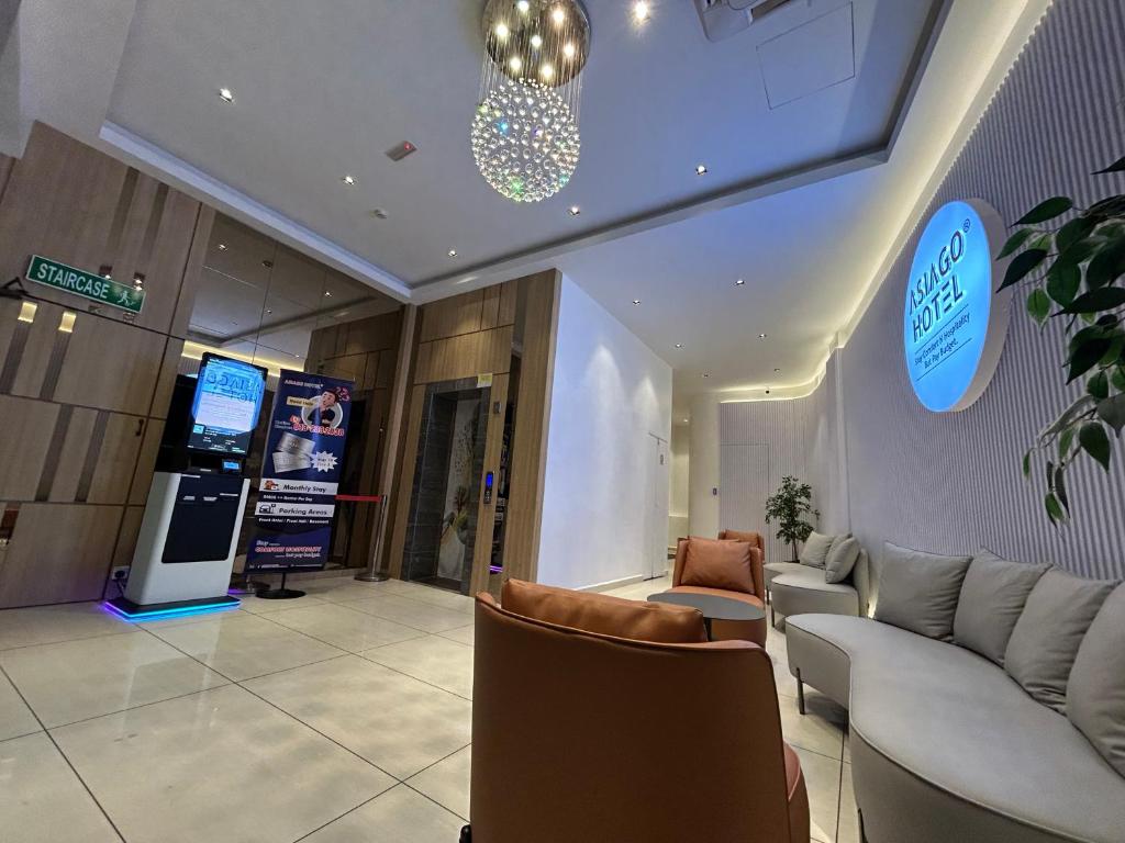 a lobby with couches and chairs in a building at Asiago Hotel in Sungai Petani