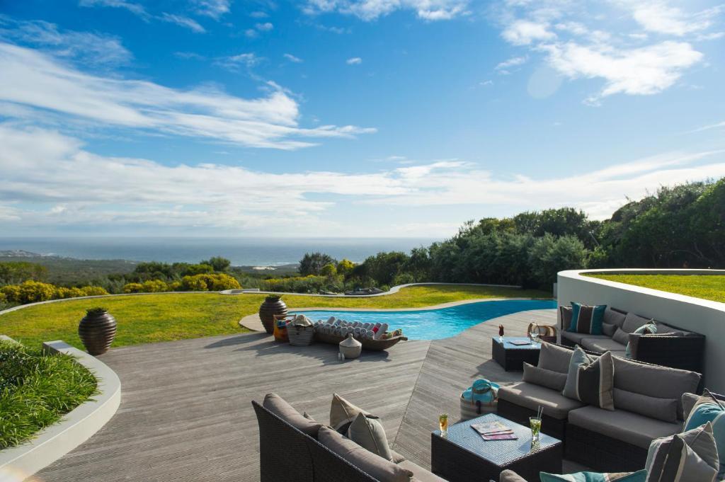 an outdoor patio with furniture and a swimming pool at Grootbos Private Nature Reserve in Gansbaai