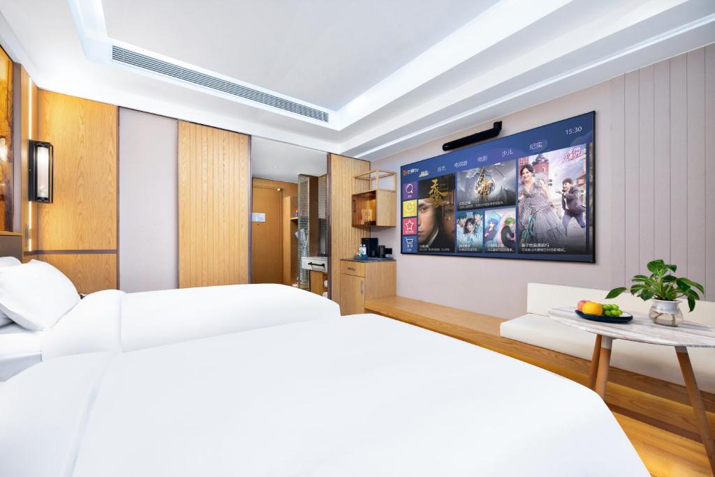 Postel nebo postele na pokoji v ubytování Jingli Hotel - Beijing New National Exhibition Capital Airport