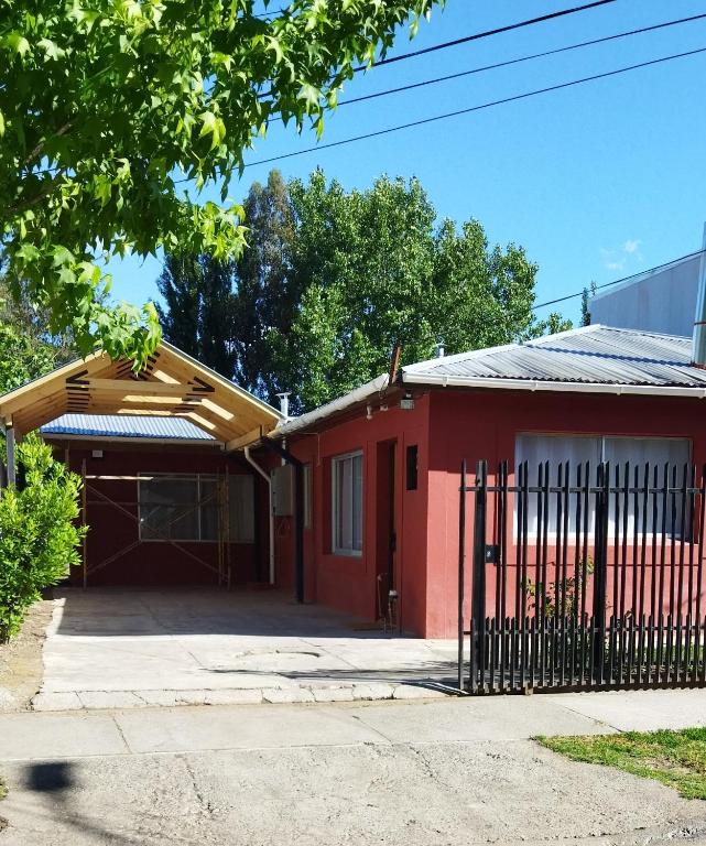 a red house with a gate in front of it at Casa Céntrica Santa Cruz valle de Colchagua-ruta del vino frente al casino y a 500 metros de la plaza ideal para teletrabajo con wifi rápido in Santa Cruz