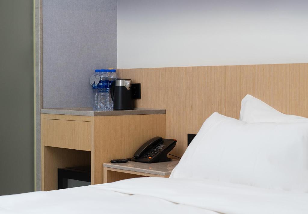 Postel nebo postele na pokoji v ubytování Guangzhou Baiyun Airport COCO Hotel
