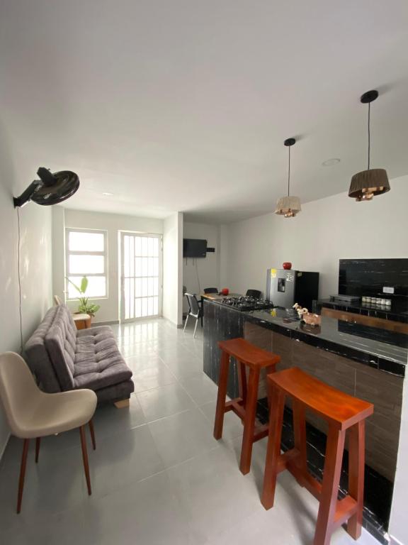 a kitchen and living room with a couch and tables at Apartamento Villa Mary-Coveñas in Coveñas
