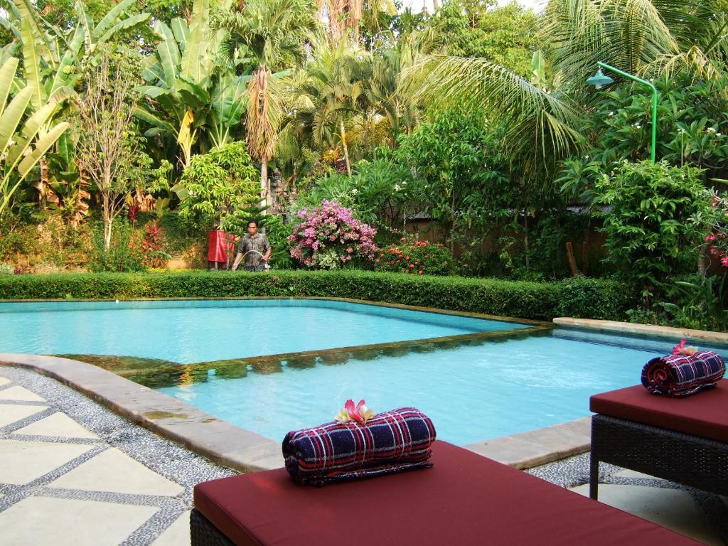 una piscina con 2 cajas en una mesa en Balinda Rooms & Villa, en Lovina