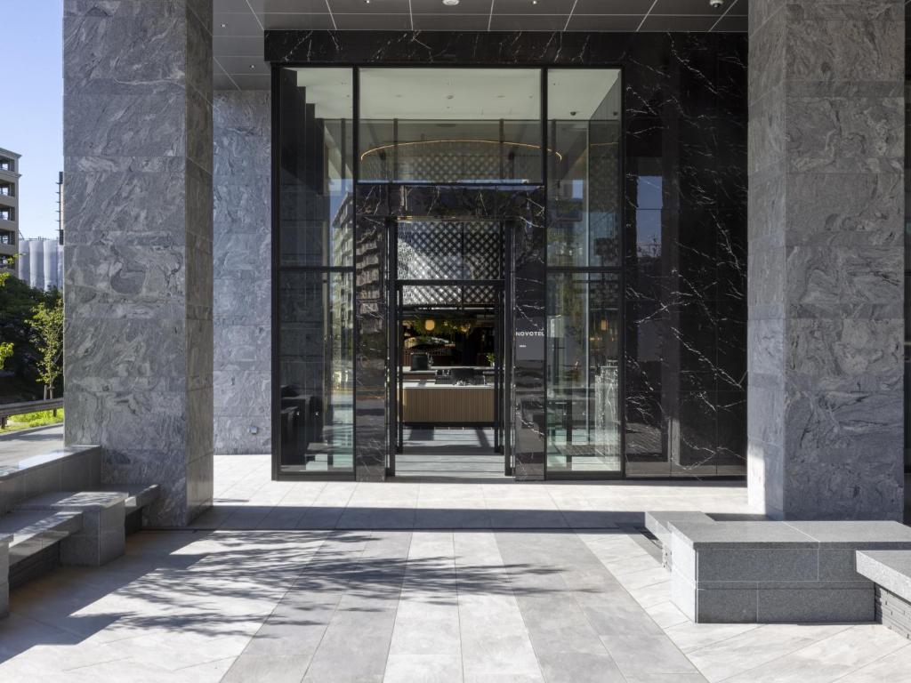 a lobby of a building with a glass doorway at Novotel Nara in Nara