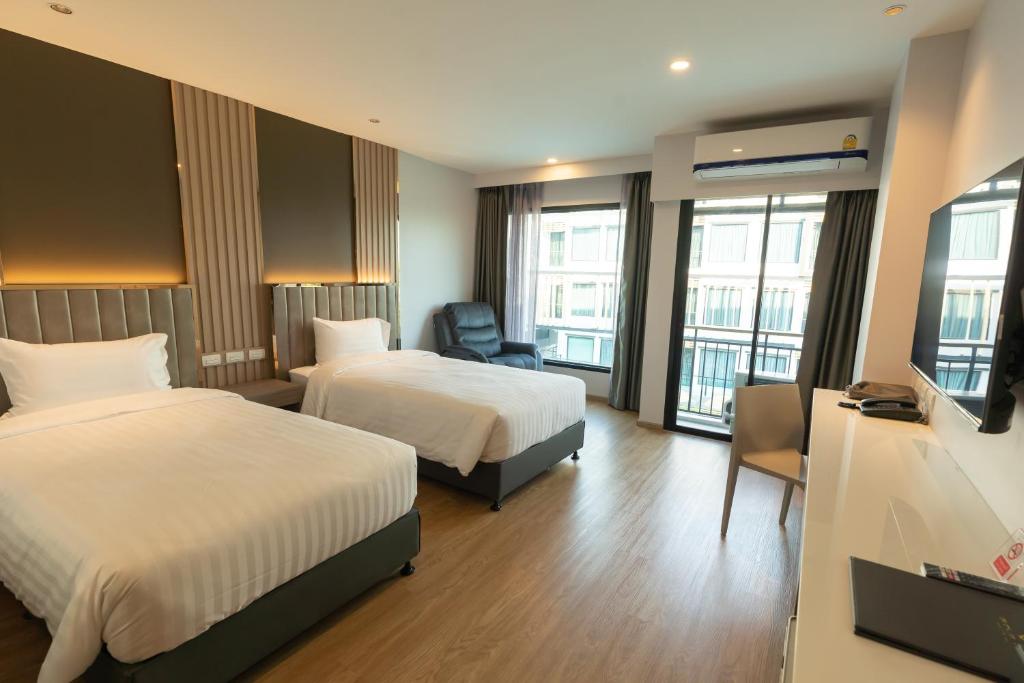 Postel nebo postele na pokoji v ubytování Crystal Srivaree Suvarnabhumi Hotel