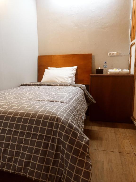 Postel nebo postele na pokoji v ubytování Watu Agung Guest House
