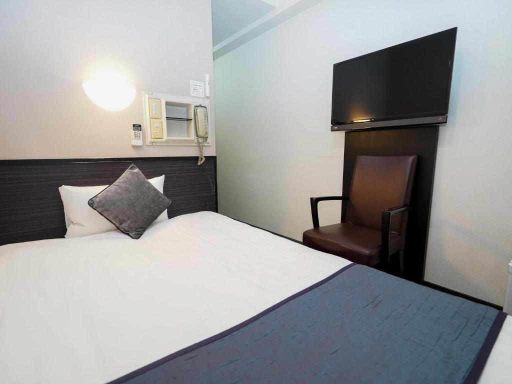 Postel nebo postele na pokoji v ubytování Hotel AreaOne Okayama