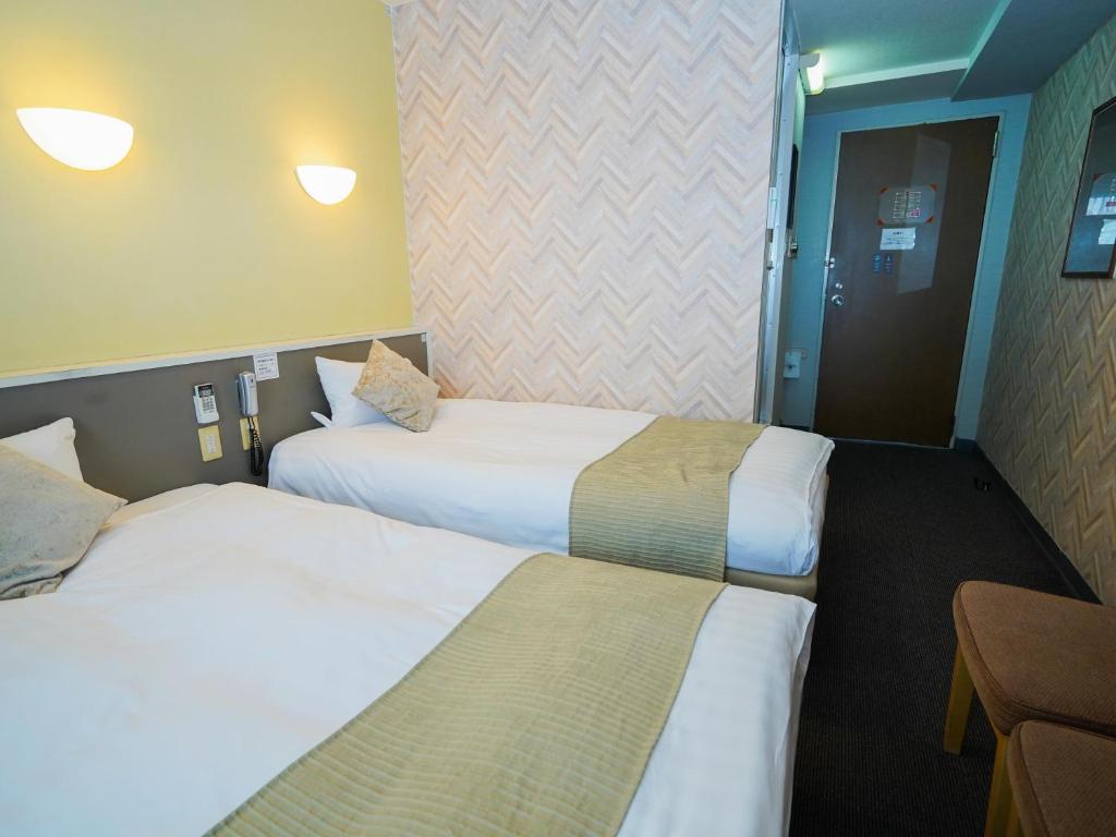 Postel nebo postele na pokoji v ubytování Hotel AreaOne Okayama