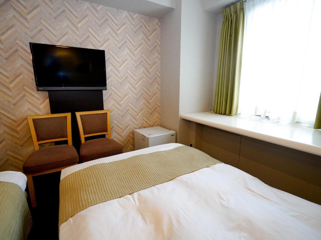 Postel nebo postele na pokoji v ubytování Hotel AreaOne Okayama