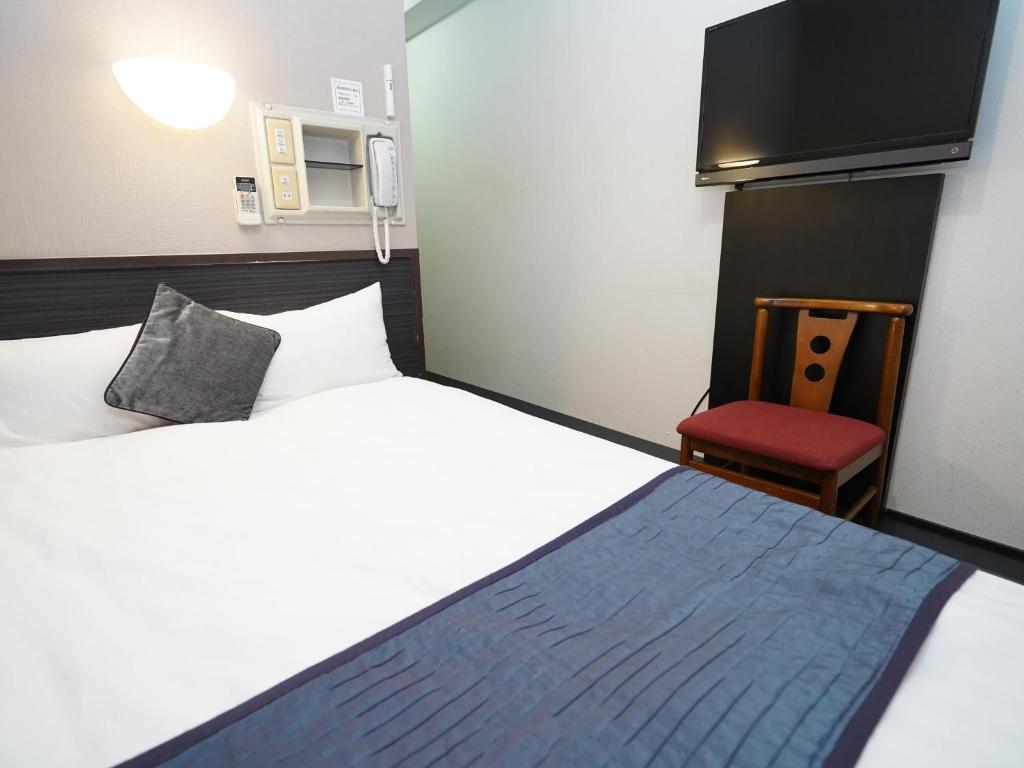 Postel nebo postele na pokoji v ubytování Hotel AreaOne Okayama