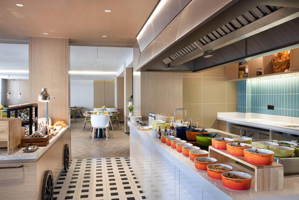 无锡Home2 Suites By Hilton Wuxi Huishan的一间大厨房,柜台上有很多食物