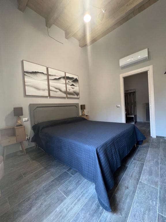 a bedroom with a bed with a blue bedspread at A casa di Linda in Tivoli