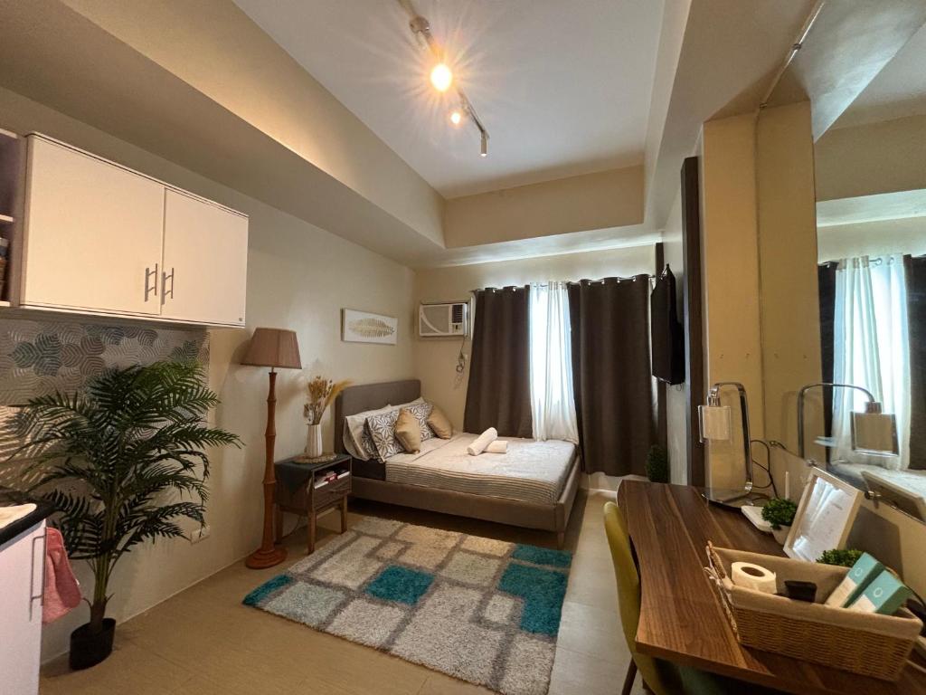 a living room with a bed and a table at Cozy & Homey Avida Towers Tower 2 in Davao City