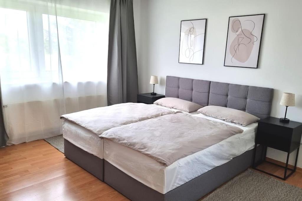 a bedroom with a large bed with two night stands at LIME HOMES Balkon, Küche, Messe, Marienburg in Sarstedt