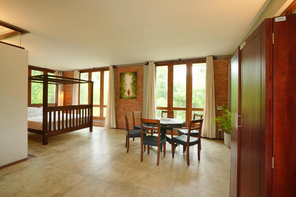 a dining room with a table and chairs and a bedroom at KoLac Villa in Elagawagoda