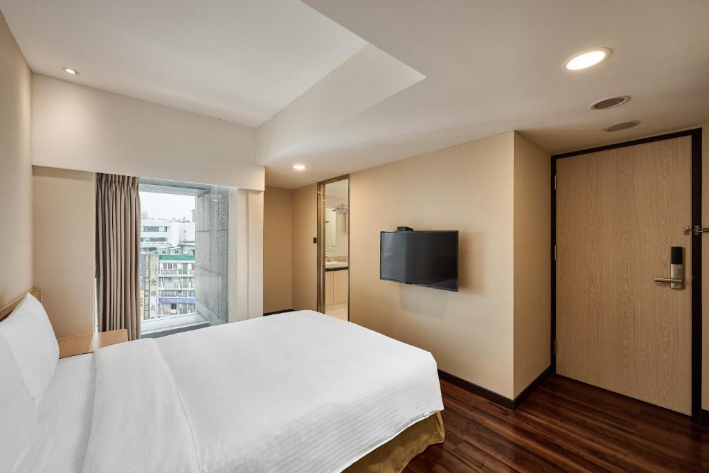 Postel nebo postele na pokoji v ubytování Eastin Taipei Hotel